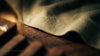 Close-up of the stitched hem of a cotton t-shirt resting on a wooden table